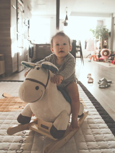 child-on-rocker-in-home