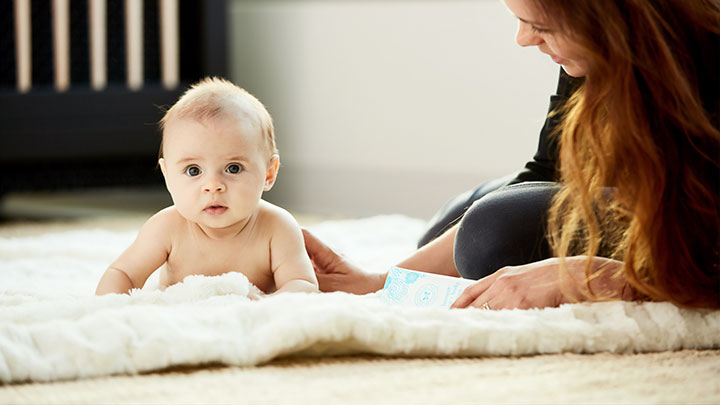 early-childhood-teacher-and-infant-on-rug
