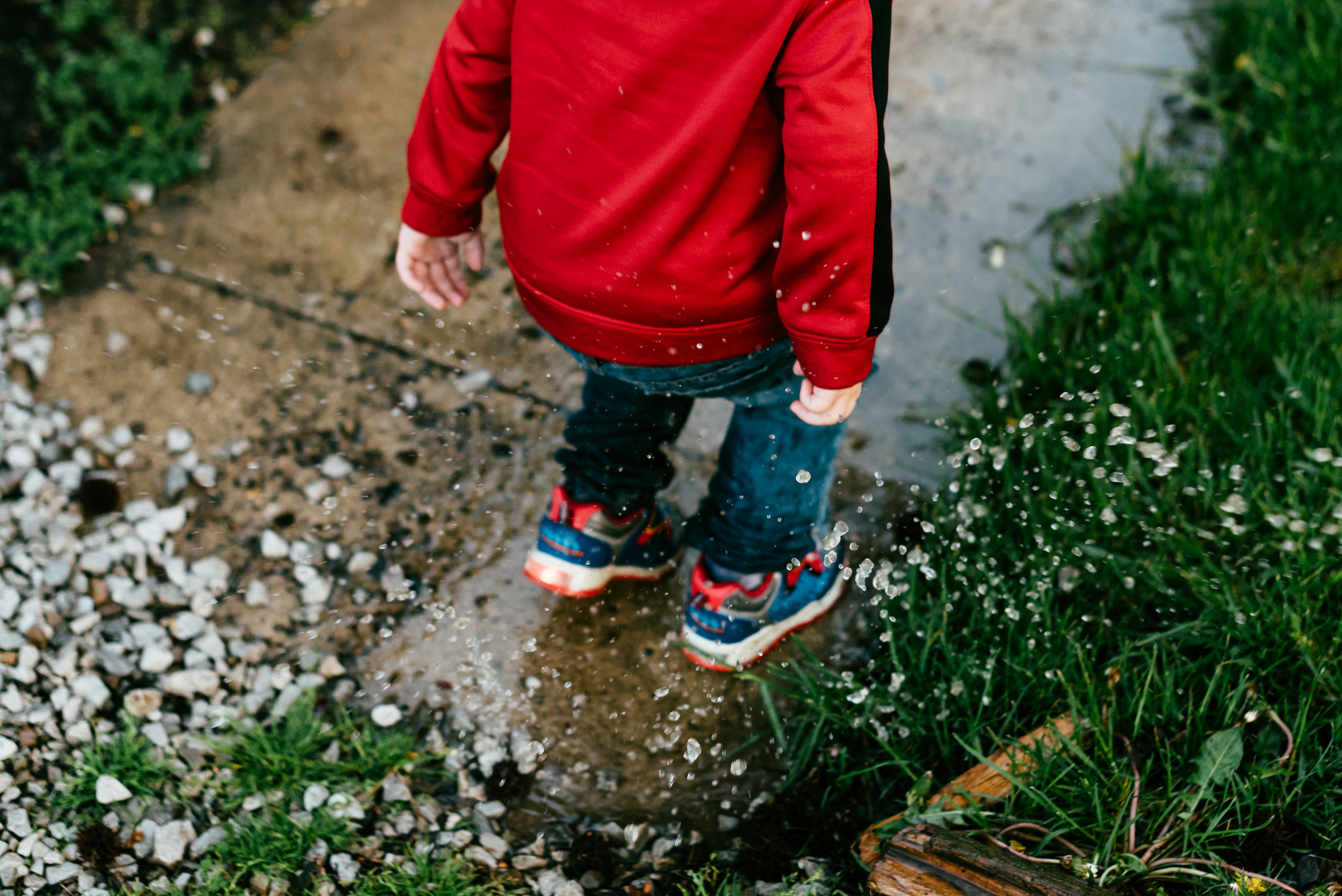 Playing outside in winter benefits in ECE child-jumping-in-puddle-ece-nz