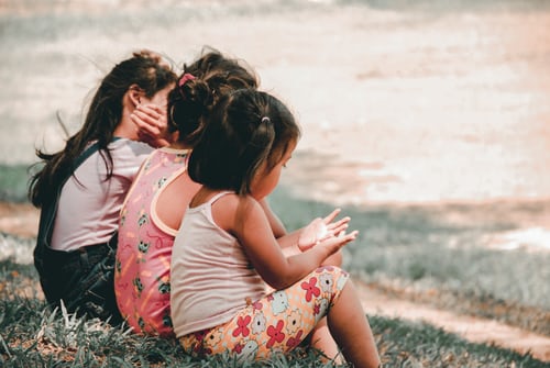 three-young-girls-sitting-on-grass