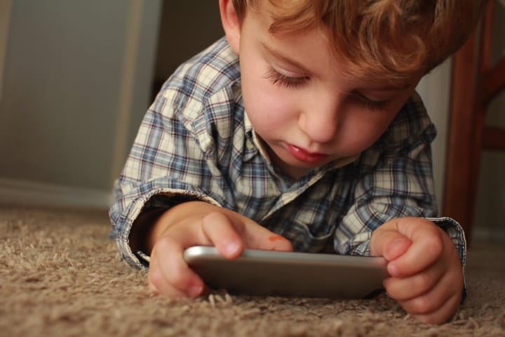 Child playing with phone